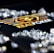 A collection of sparkling, clear gemstones surrounds a dark surface featuring the prominent logo and text 'Real Poker.' The logo design includes gold and white elements set against a black background.